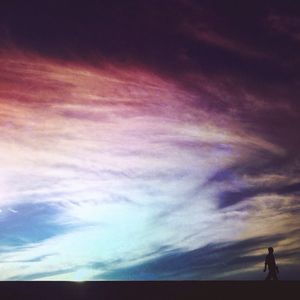 Scenic view of sea against cloudy sky at sunset