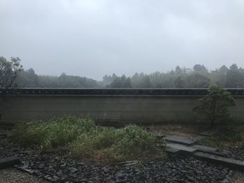 Scenic view of river by buildings against sky