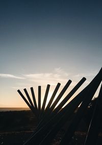 Metallic structure against sky at sunset