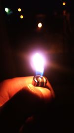 Close-up of hand holding illuminated lights