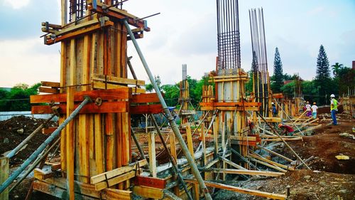 Cranes at construction site against sky