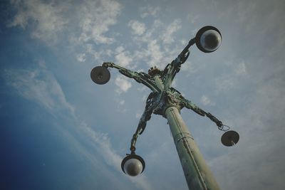 Low angle view of cross statue against sky