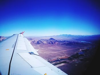 Aerial view of mountain against blue sky