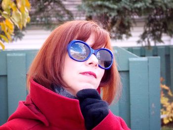 Close-up portrait of young woman wearing sunglasses