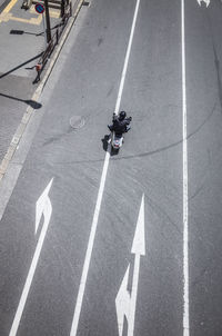 High angle view of man crossing sign on road