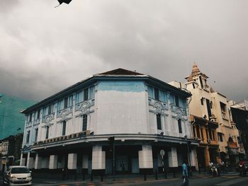 Low angle view of building against cloudy sky