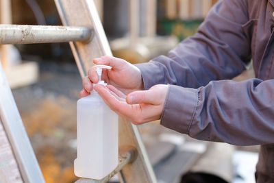 Close-up of man holding bottle