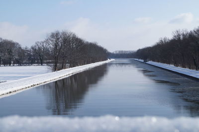 Surface level of frozen lake against sky