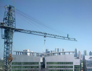 Low angle view of electricity pylon against clear sky