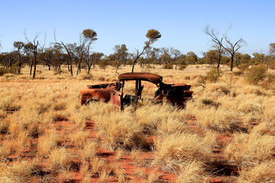 Abandoned truck on field against sky