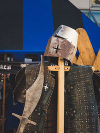 Close-up of clothes hanging on wood against wall