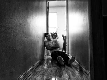 Depressed young man sitting on floor