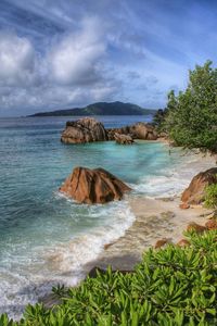 Scenic view of sea against cloudy sky