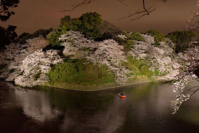 High angle view of river by hill during dusk