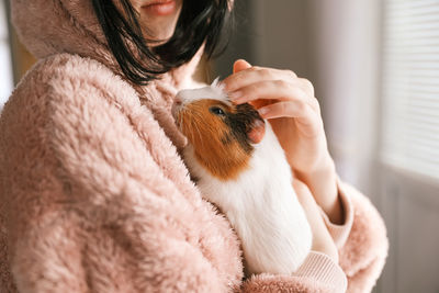Portrait of young woman with teddy bear