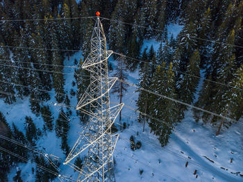 High angle view electrical pylon on snow covered land