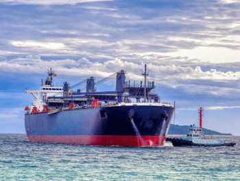 Container ship in sea against sky