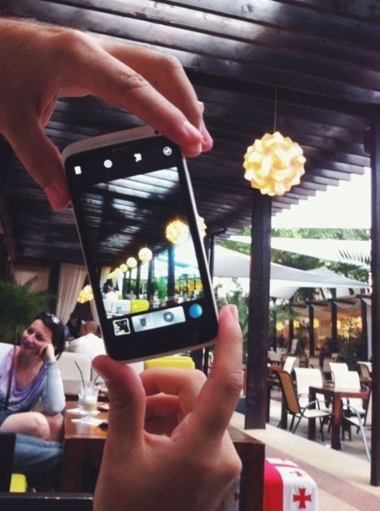 WOMAN HOLDING SMART PHONE