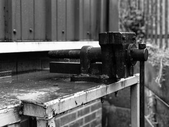 Rusty machine part on table outdoors