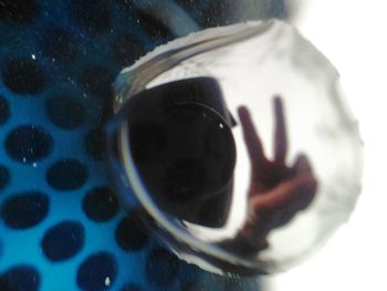 Close-up of hand photographing reflection