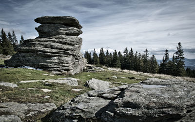 Stack of rocks on land against sky