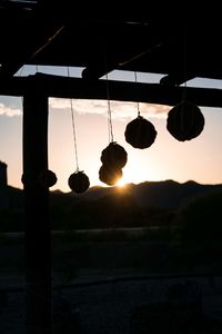 Low angle view of lights against sky during sunset