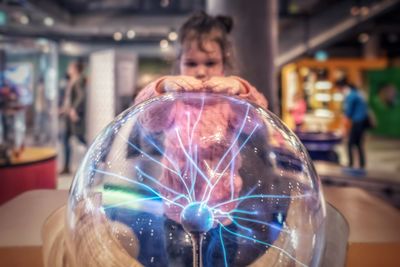 Girl touching plasma ball