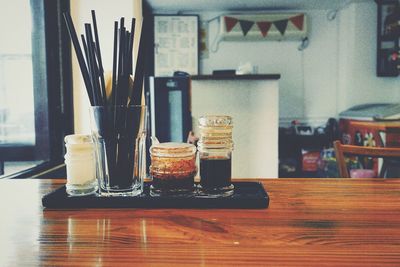 Sauce and drinking straws in glass on restaurant table