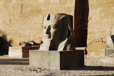 Statue of buddha against wall