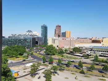 View of city buildings against clear sky