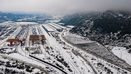 High angle view of railroad tracks amidst buildings during winter