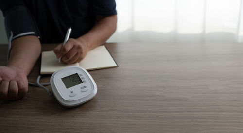 Midsection of man working on table