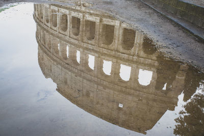 Reflection of building in puddle