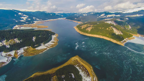 Aerial view of sea and mountain against sky