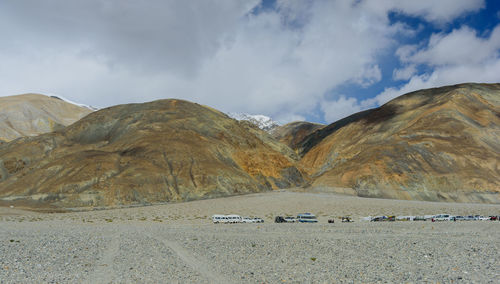 Scenic view of land and mountains against sky