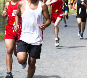 Low section of people running on street