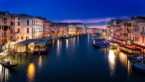 Canal passing through city at night