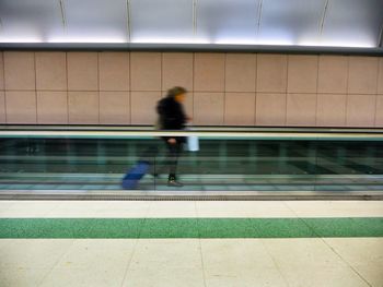 Blurred motion of person walking at railroad station