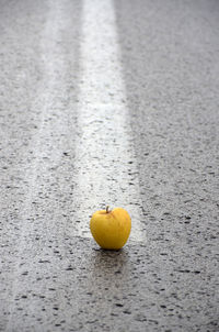 Close-up of yellow fruit on road