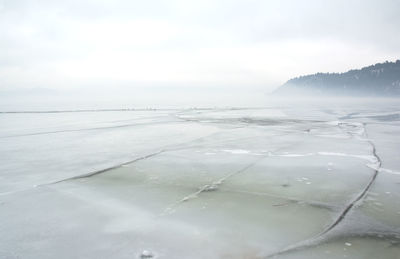 Frozen lake with cracks on the surface