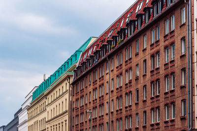 Low angle view of building against cloudy sky