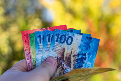 Cropped hand holding paper currency