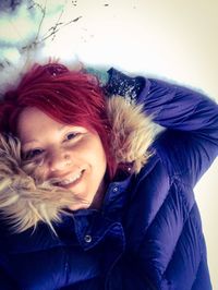 Portrait of smiling young woman in snow