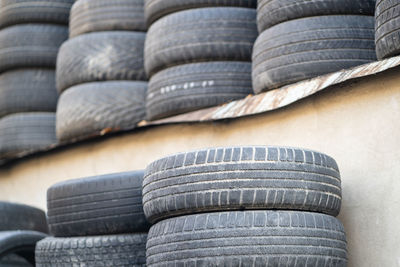 Old used rubber tires stacked with high piles. hazardous waste requiring recycling and disposal.