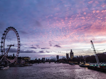 Ferris wheel in city at sunset