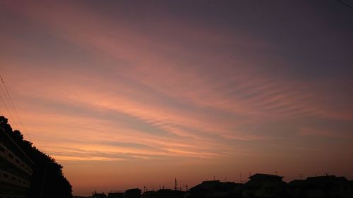 City against sky at sunset