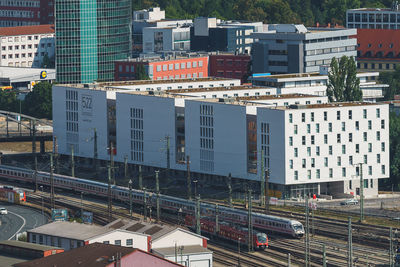 High angle view of railroad tracks amidst buildings in city