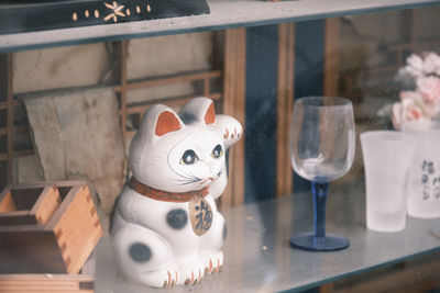 Close-up of fortune cat on table