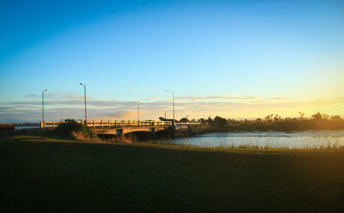 Scenic view of river against sky during sunset