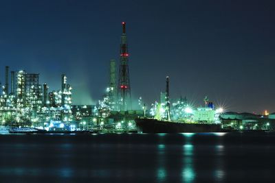 Illuminated commercial dock against sky at night